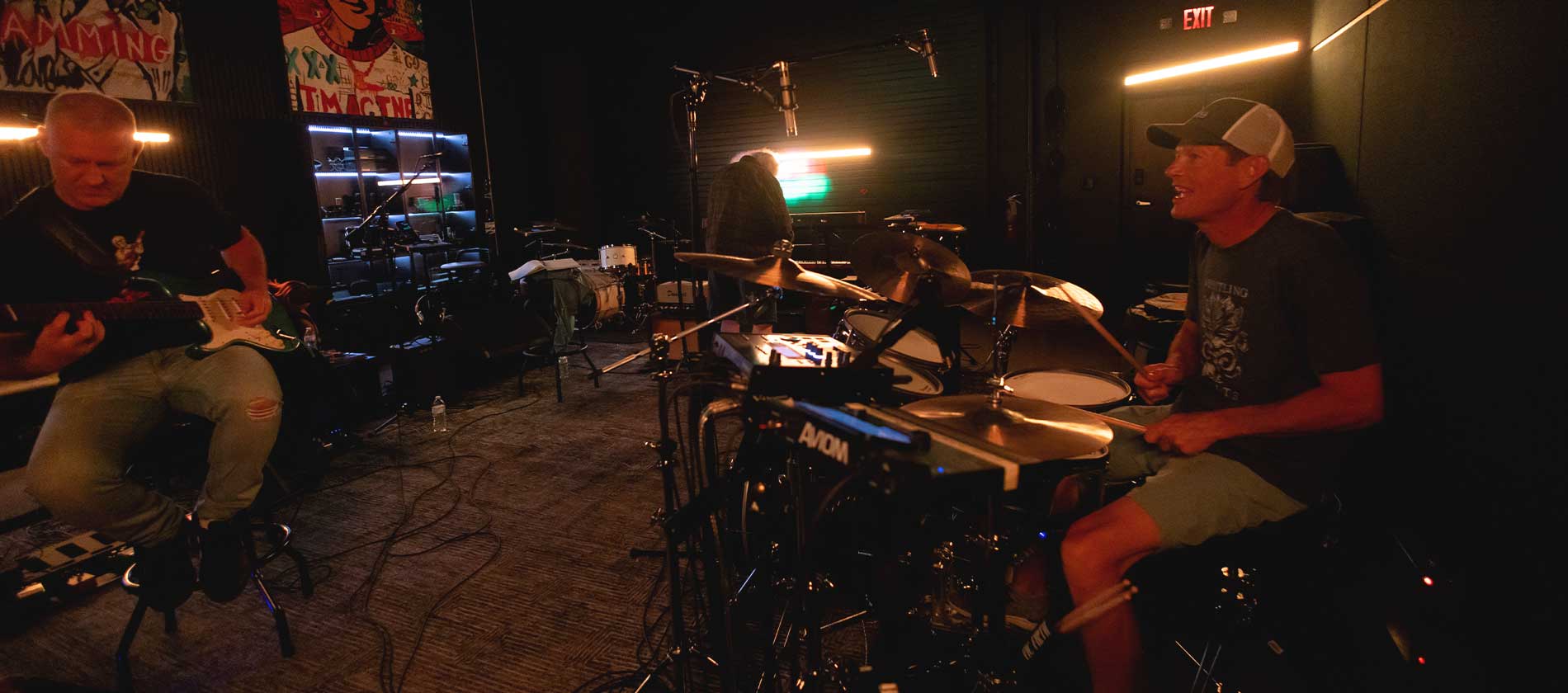 Band rehearsing in Lulu Studio, guitarist and drummer in the foreground